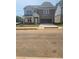 Two-story brick home with a two-car garage, covered porch, and manicured lawn in a suburban neighborhood at 1079 Georgian Point Dr, Lawrenceville, GA 30045
