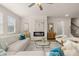 Bright living room features a fireplace, ceiling fan, and windows that bring in plenty of natural light at 1079 Georgian Point Dr, Lawrenceville, GA 30045