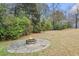 Fire pit in the backyard featuring stone pavers, a stone fire pit, and an area for seating at 1228 Church St, Decatur, GA 30030