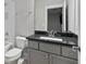 Well-lit bathroom with granite counters, gray cabinets and subway tile in the shower at 1228 Church St, Decatur, GA 30030