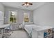 Bright bedroom with white decor, large windows, work desk, and ceiling fan at 1228 Church St, Decatur, GA 30030