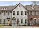 Charming exterior of townhome featuring a white brick facade and black iron fencing at 1228 Church St, Decatur, GA 30030