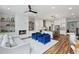 Open-concept living area with hardwood floors, fireplace, and adjacent kitchen at 1228 Church St, Decatur, GA 30030