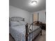 Calming bedroom with a metal frame bed, neutral walls, and carpet with two windows at 1871 Shiloh Valley Nw Way, Kennesaw, GA 30144