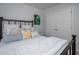 This comfy bedroom has a large bed with multiple pillows and a double door closet at 1871 Shiloh Valley Nw Way, Kennesaw, GA 30144