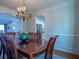 Elegant dining room featuring a chandelier, wainscoting, and a view into the living room at 1871 Shiloh Valley Nw Way, Kennesaw, GA 30144