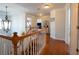 Bright upstairs hallway with wood floors, decorative lighting and staircase with wooden railing at 1871 Shiloh Valley Nw Way, Kennesaw, GA 30144
