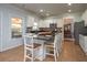 Bright kitchen featuring white cabinetry, granite countertops, an island with barstool seating, and modern appliances at 1871 Shiloh Valley Nw Way, Kennesaw, GA 30144