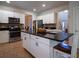 Bright kitchen featuring white cabinetry, granite countertops, an island with barstool seating, and modern appliances at 1871 Shiloh Valley Nw Way, Kennesaw, GA 30144