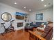 Cozy living room with a fireplace, built-in shelving, comfortable seating, and ample natural light at 1871 Shiloh Valley Nw Way, Kennesaw, GA 30144