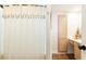 Well-lit bathroom featuring a decorative shower curtain, linen cabinet, and neutral finishes at 3777 Peachtree Ne Rd # 1530, Atlanta, GA 30319
