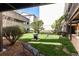 Serene courtyard featuring a grassy lawn, mature trees, lush landscaping, and a charcoal grill at 3777 Peachtree Ne Rd # 1530, Atlanta, GA 30319