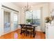 Cozy dining area with modern lighting fixture, wooden floors and natural light from windows and French doors at 3777 Peachtree Ne Rd # 1530, Atlanta, GA 30319