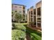 Exterior of beige condo building next to a parking garage with green landscaping at 3777 Peachtree Ne Rd # 1530, Atlanta, GA 30319