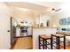 Open kitchen with stainless steel appliances, counter seating, and a view into the adjacent living area at 3777 Peachtree Ne Rd # 1530, Atlanta, GA 30319