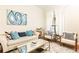 Bright living room with a comfortable seating area, contemporary art, and natural light from the window at 3777 Peachtree Ne Rd # 1530, Atlanta, GA 30319