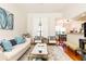 Cozy living room with hardwood floors, stylish seating, and an open view into the adjacent dining area at 3777 Peachtree Ne Rd # 1530, Atlanta, GA 30319