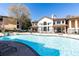 Community pool with a waterfall feature, lounge chairs, and a view of the clubhouse at 3777 Peachtree Ne Rd # 1530, Atlanta, GA 30319