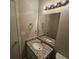 Bathroom with granite countertop, white vanity, and modern lighting fixture above the mirror at 6406 Laurel Post Dr, Lithonia, GA 30058