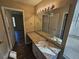 Bright bathroom with granite countertops and modern vanity lighting reflecting in the large mirror at 6406 Laurel Post Dr, Lithonia, GA 30058