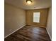 Bedroom with wood-look flooring and a window at 6406 Laurel Post Dr, Lithonia, GA 30058
