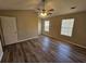 Bedroom with wood-look flooring, two windows, and a ceiling fan with lights at 6406 Laurel Post Dr, Lithonia, GA 30058