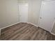 Bedroom with wood-look flooring and two doors at 6406 Laurel Post Dr, Lithonia, GA 30058