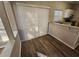 Charming dining area with hardwood floors, a breakfast bar, and sliding glass doors for easy outdoor access at 6406 Laurel Post Dr, Lithonia, GA 30058