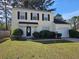 Inviting two-story home features a well-manicured front yard and a classic design with black shutters at 6406 Laurel Post Dr, Lithonia, GA 30058