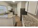 Modern kitchen with granite counters, stainless appliances and stylish white cabinets, perfect for cooking at 6406 Laurel Post Dr, Lithonia, GA 30058