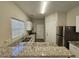 Well-lit kitchen featuring white cabinets, stainless steel appliances, and gorgeous granite countertops at 6406 Laurel Post Dr, Lithonia, GA 30058