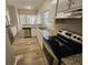 Modern kitchen featuring stainless steel appliances, white cabinetry, and great counterspace with granite counters at 6406 Laurel Post Dr, Lithonia, GA 30058