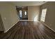 Bright living room boasts new hardwood flooring and ample natural light from a large front window at 6406 Laurel Post Dr, Lithonia, GA 30058