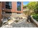 Backyard patio area with stone retaining wall, gas grill, and outdoor seating at 1065 United Ave # 208, Atlanta, GA 30316