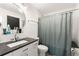 Bright bathroom featuring a shower, modern vanity, a round mirror and tile walls at 1065 United Ave # 208, Atlanta, GA 30316