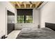 A bedroom with concrete floors, a dark accent wall, large windows, and a minimalist style at 1065 United Ave # 208, Atlanta, GA 30316