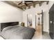 Bedroom with a view to the kitchen and bathroom, concrete floors, and an exposed ceiling at 1065 United Ave # 208, Atlanta, GA 30316