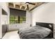 A bedroom with concrete floors, a dark accent wall, large windows, and a minimalist style at 1065 United Ave # 208, Atlanta, GA 30316
