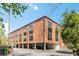 This is the exterior of a brick building with large windows and covered parking at 1065 United Ave # 208, Atlanta, GA 30316