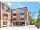 Building exterior featuring brick facade, large windows, and covered parking at 1065 United Ave # 208, Atlanta, GA 30316