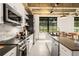 Modern kitchen with stainless steel appliances and sleek cabinets, open shelving, and black countertops at 1065 United Ave # 208, Atlanta, GA 30316