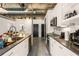 Modern kitchen with stainless steel appliances, sleek countertops, exposed pipes, and ample cabinet space at 1065 United Ave # 208, Atlanta, GA 30316