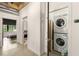 Hallway with a stacked washer and dryer inside the closet and a view to the bedroom at 1065 United Ave # 208, Atlanta, GA 30316