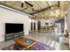 Spacious open-concept living area with exposed pipes, a modern kitchen, and plenty of natural light at 1065 United Ave # 208, Atlanta, GA 30316