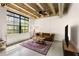 A well-lit living room with a vintage sofa, concrete floors, large windows, and an exposed ceiling at 1065 United Ave # 208, Atlanta, GA 30316