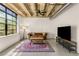 Bright living room with large windows, vintage sofa, concrete floors, and a patterned rug at 1065 United Ave # 208, Atlanta, GA 30316