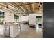 Open living space with a sleek kitchen, comfortable seating, exposed pipes, and ample natural light at 1065 United Ave # 208, Atlanta, GA 30316