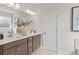 Bright bathroom featuring double vanity, quartz counters, framed mirror and neutral color palette at 1613 Caldwell Bend Ln, Dacula, GA 30019