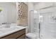 Modern bathroom with a sleek vanity, framed mirror, and glass-enclosed shower with white tile at 1613 Caldwell Bend Ln, Dacula, GA 30019