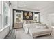 This well-lit bedroom features a large window, trey ceilings, and a bench in the corner at 1613 Caldwell Bend Ln, Dacula, GA 30019